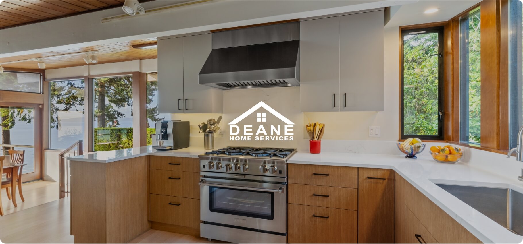 A modern kitchen featuring sleek cabinetry and a spacious countertop with natural light streaming in.