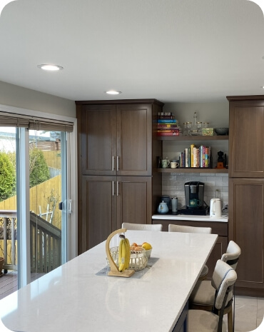 A kitchen that opens up to a deck, showcasing indoor-outdoor living.